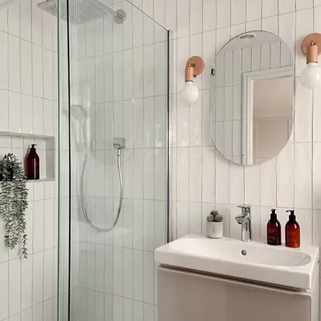 Vertical stacked fully tiled white bathroom